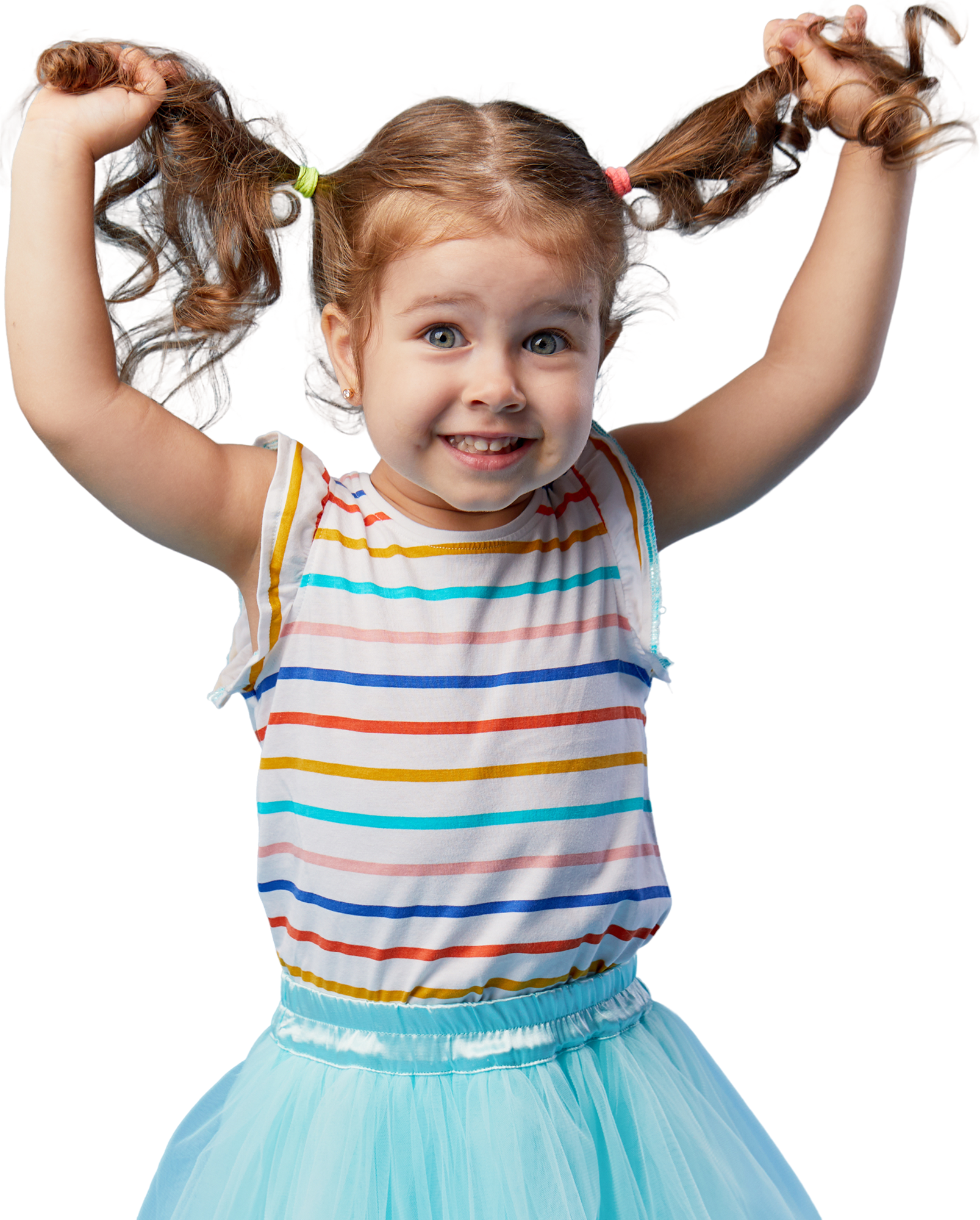 Smiling young girl with pigtails wearing a striped shirt and blue skirt, playfully lifting her hair on both sides.
