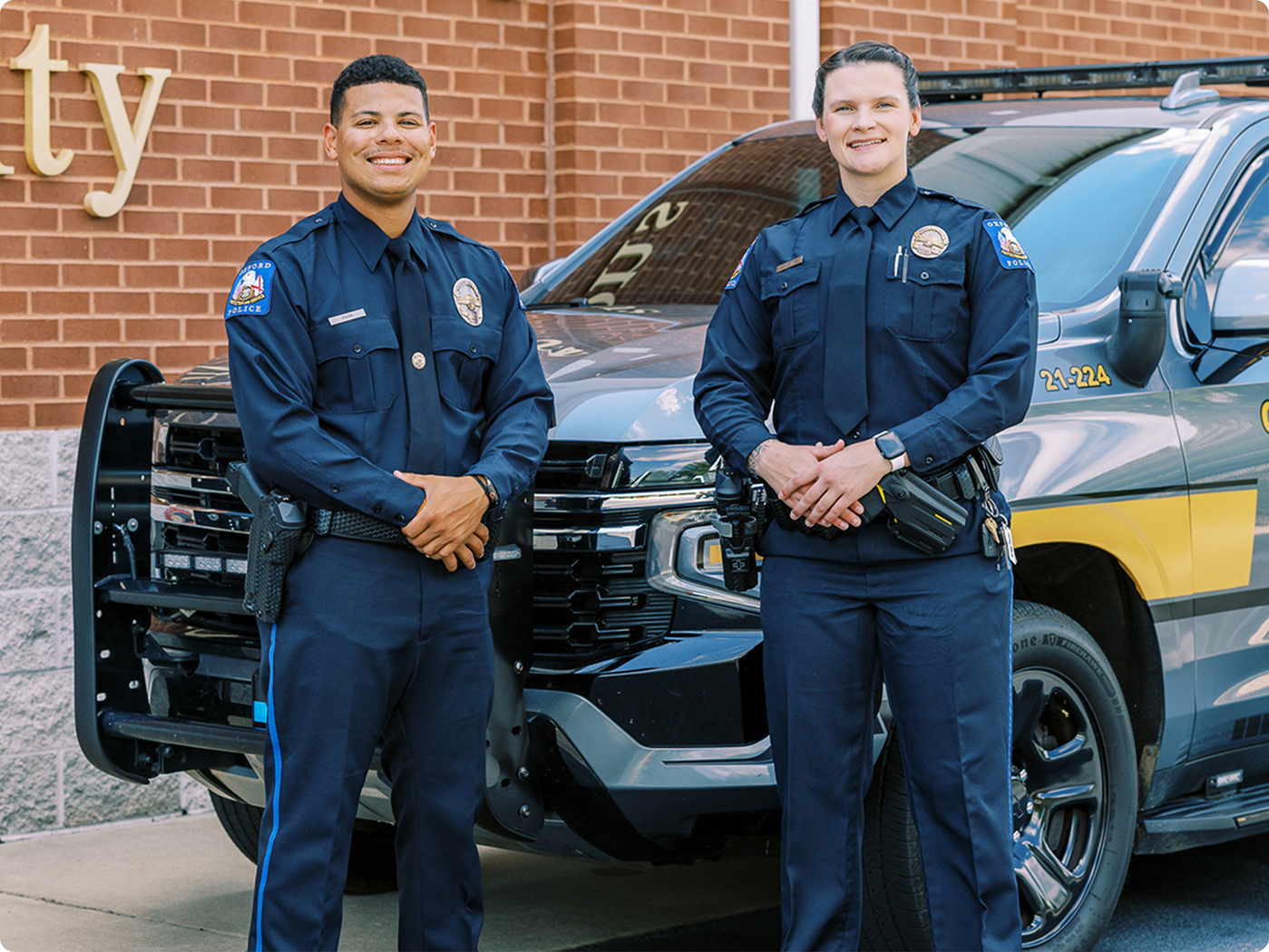 Police officers next to a squad car